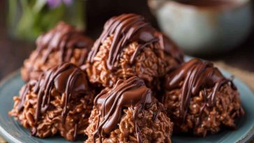 The Best Chocolate Haystacks made with melted chocolate, crunchy chow mein noodles, and shredded coconut, stacked into bite-sized clusters and served on a dessert tray.