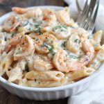 Creamy shrimp pasta with garlic sauce and tender shrimp over noodles.