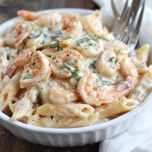 Creamy shrimp pasta with garlic sauce and tender shrimp over noodles.