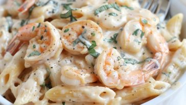 Creamy shrimp pasta with garlic sauce and tender shrimp over noodles.