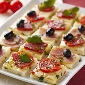 Layered antipasto squares with deli meats, cheese, and vegetables baked between flaky pastry.