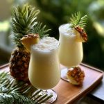Pina colada cocktail with pineapple slice and cherry garnish