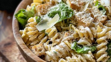 Caesar pasta salad with romaine lettuce, pasta, and Parmesan cheese.