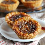Classic Canadian butter tarts with flaky pastry shells filled with a rich, gooey caramel-like filling.