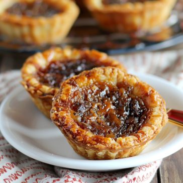 Classic Canadian butter tarts with flaky pastry shells filled with a rich, gooey caramel-like filling.