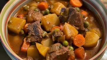 Hearty homemade beef stew with tender beef, carrots, and potatoes in rich broth.
