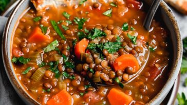 Hearty lentil soup with vegetables in a warm, savory broth.