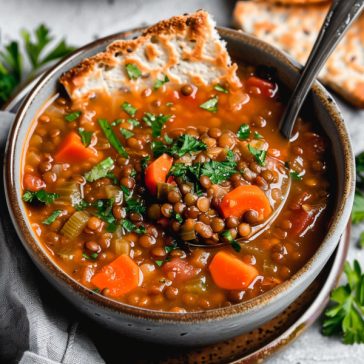 Hearty lentil soup with vegetables in a warm, savory broth.