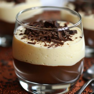Light vanilla mousse layered with rich chocolate, topped with chocolate shavings and served in a glass dessert cup.