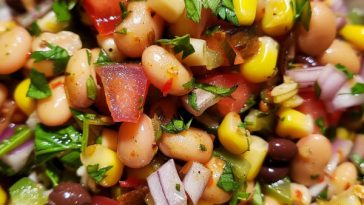 Colorful cowboy caviar made with black beans, corn, tomatoes, avocado, and peppers tossed in a fresh dressing.