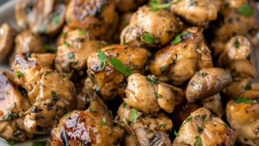 Low carb mushroom chicken bites cooked in a savory garlic sauce with fresh herbs and sautéed mushrooms.