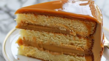 Moist caramel cake layered with rich caramel frosting and drizzled with glossy caramel sauce.