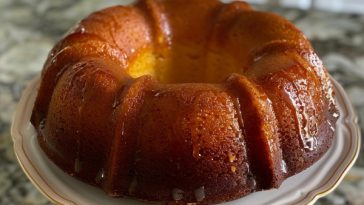 Golden rum cake with a moist crumb soaked in buttery rum glaze and topped with a glossy finish.