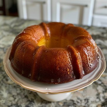 Golden rum cake with a moist crumb soaked in buttery rum glaze and topped with a glossy finish.