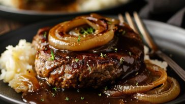 Juicy hamburger steak topped with caramelized onions and rich brown gravy.