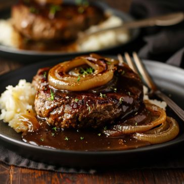 Juicy hamburger steak topped with caramelized onions and rich brown gravy.