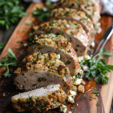 Stuffed pork tenderloin sliced to reveal savory filling inside.