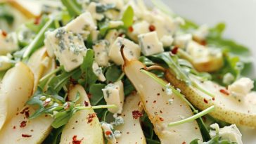 Roquefort pear salad with fresh greens, nuts, and creamy blue cheese.