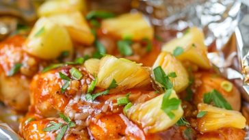 Juicy BBQ chicken foil pack with pineapple chunks, bell peppers, and sauce, cooked to perfection in a foil packet.