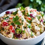 Classic creamy chicken salad served in a bowl with fresh herbs.