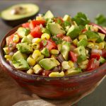 Avocado corn salad with fresh herbs and a zesty dressing.