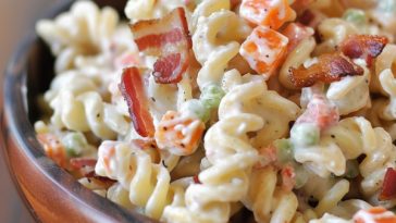 Creamy bacon ranch pasta salad with pasta, bacon, and fresh vegetables.