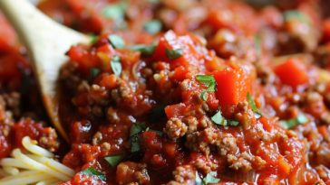 Spaghetti topped with rich meat sauce, hearty and flavorful.