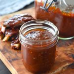 Homemade BBQ sauce simmering in a pot with a rich, glossy texture and deep smoky color.