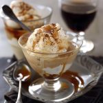 Affogato dessert with a scoop of vanilla ice cream topped with hot espresso, creating a creamy coffee treat.