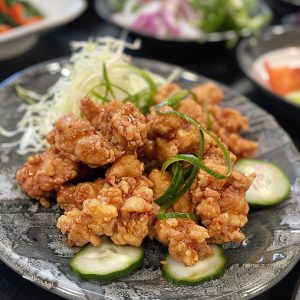 Crispy Japanese chicken karaage pieces fried to golden perfection and served with lemon wedges.