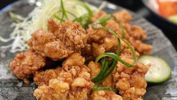 Crispy Japanese chicken karaage pieces fried to golden perfection and served with lemon wedges.