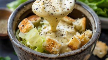 Creamy homemade Caesar salad dressing with garlic, parmesan cheese, and anchovy blended until smooth.