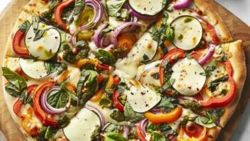 Freshly baked veggie pizza topped with colorful bell peppers, mushrooms, onions, and melted cheese.