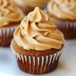 Light and fluffy peanut butter frosting swirled smoothly on a cake or cupcake.