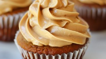 Light and fluffy peanut butter frosting swirled smoothly on a cake or cupcake.