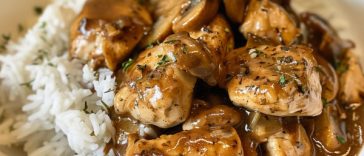 Chicken Marsala served over white rice with a rich mushroom wine sauce and fresh herbs.
