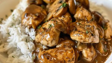 Chicken Marsala served over white rice with a rich mushroom wine sauce and fresh herbs.