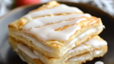 Homemade toaster strudel with flaky pastry, sweet fruit filling, and icing drizzle on top.