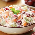 Creamy grape fruit salad made with fresh grapes, pineapple, and a sweet cream dressing served in a chilled bowl.