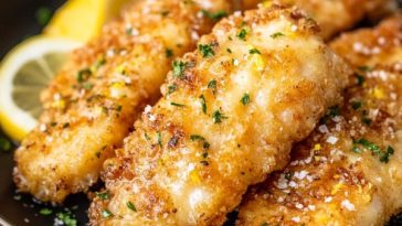 Golden lemon butter chicken tenders sautéed in a skillet with garlic, fresh herbs, and a zesty lemon butter sauce.