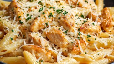 Creamy garlic parmesan chicken pasta inspired by Buffalo Wild Wings, topped with tender chicken, parmesan cheese, and herbs.