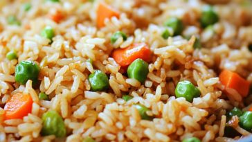 Colorful very veggie fried rice with carrots, peas, broccoli, corn, and bell peppers served in a skillet.