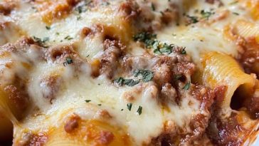 Unstuffed shells pasta baked with marinara sauce, ricotta, mozzarella, and Italian herbs in a casserole dish.