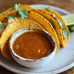 Homemade taco sauce in a jar with chili peppers and spices
