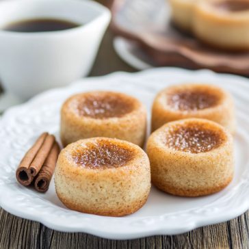 Four round pastries with cinnamon