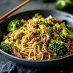 Chinese beef and broccoli noodles stir-fried with soy garlic sauce, served in a bowl.