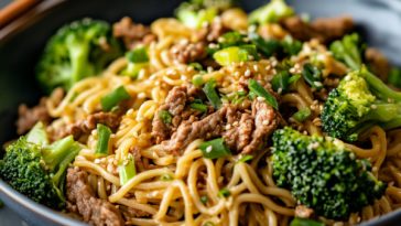 Chinese beef and broccoli noodles stir-fried with soy garlic sauce, served in a bowl.