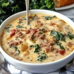 Bowl of creamy Zuppa Toscana soup with sausage, potatoes, and kale