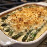 Cheesy asparagus gratin baked golden in a casserole dish