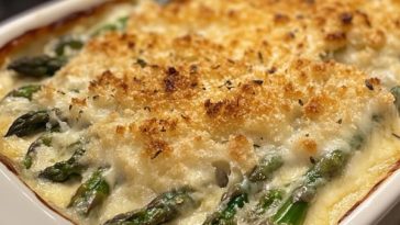 Cheesy asparagus gratin baked golden in a casserole dish